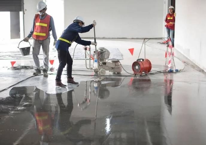 Boise Epoxy Solutions crew grinding and preparing a concrete floor